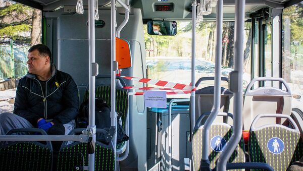 Пассажир едет в пустом автобусе в защитных перчатках. Кабина водителя огорожена пластиковой защитой. В Грузии борются с коронавирусом - Sputnik Грузия