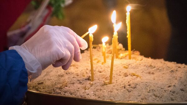 Вербное воскресенье в столице Грузии в условиях карантина. Верующие в перчатках зажигают свечи - Sputnik Грузия