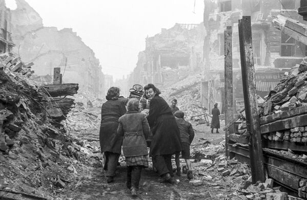 Жители Берлина возвращаются домой по заваленной обломками улице. Бои закончились. Май 1945 года - Sputnik Грузия