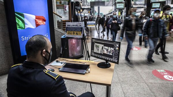 Охранник проверяет пассажиров на вокзале в Милане после этапного завершения карантина в Италии - Sputnik Грузия