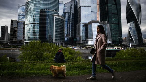 Девушка во время прогулки с собакой на набережной Тараса Шевченко в Москве - Sputnik Грузия