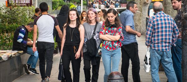 Прохожие идут по улице. Молодые девушки без масок. Снятие ограничений и открытие магазинов, кафе и ресторанов в столице Грузии - Sputnik Грузия