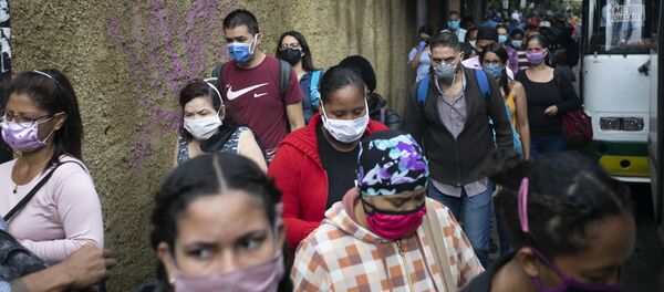 Пешеходы в масках идут по улице в Каракасе, Венесуэла. Пандемия коронавируса не отступает Пешеходы в масках идут по улице в Каракасе, Венесуэла. Пандемия коронавируса не отступает - Sputnik Грузия